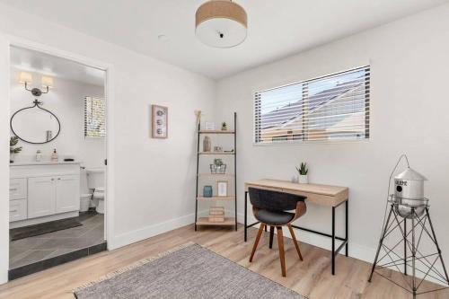 a white bathroom with a desk and a sink at Casita 5 minutes from Gruene Hall and King Bed! in New Braunfels