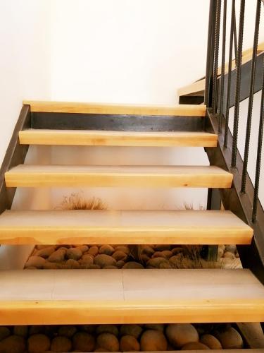 a set of stairs with rocks underneath them at Hotel Costanera in Puerto Natales