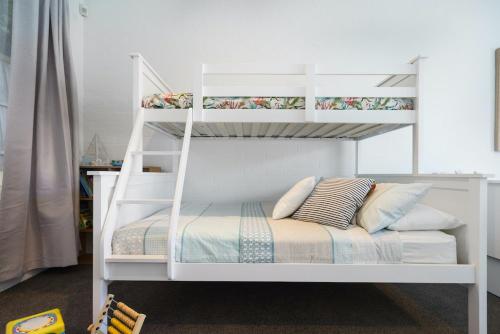 a white bunk bed with pillows on top of it at The Portsea Hideaway in Portsea