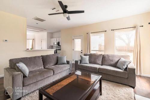 a living room with a couch and a coffee table at Grand Gem for Families - Games, Office, Backyard in Carrollton