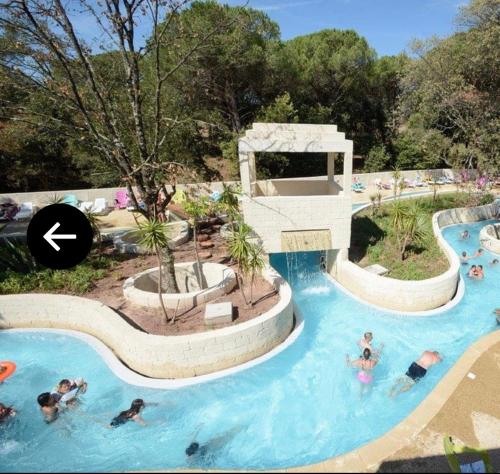 a group of people in a swimming pool at a resort at Camping les Cigales - Mobil-home 4/6 personnes in Le Muy