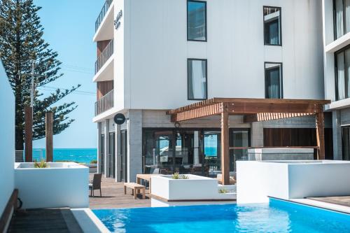 a hotel swimming pool with a view of the ocean at Sudima Kaikōura in Kaikoura