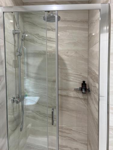 een douche met een glazen deur in de badkamer bij Royal View in Ramsgate