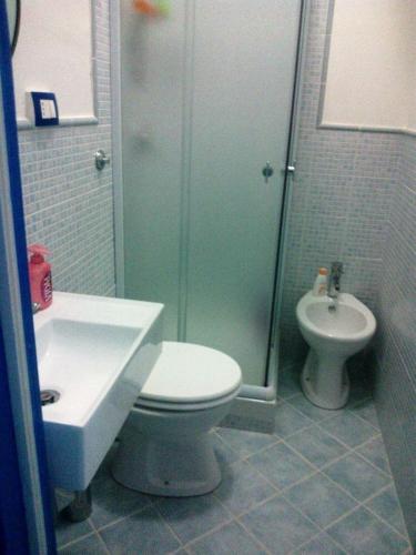 a bathroom with a toilet and a sink and a shower at B&B Mammaliturchi SCALA DEI TURCHI in Realmonte