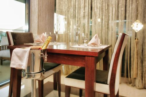 a dining room with a wooden table and chairs at Monte Casa SPA & Wellness in Petrovac na Moru