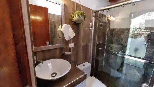 a bathroom with a sink and a shower at Huandoy Lodge - Huaraz in Yungay