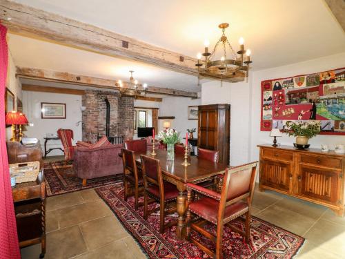 a dining room with a wooden table and chairs at Gatehouse Croft in Newton Regis