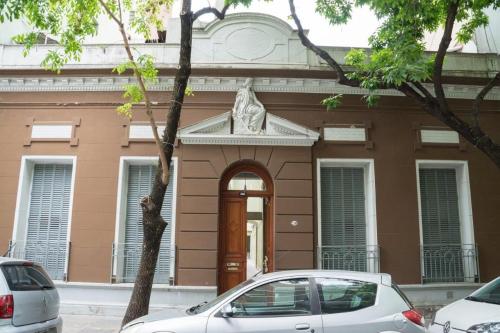 un edificio con una puerta y un coche aparcado delante en Departamento con patio en excelente ubicación en Belgrano en Buenos Aires