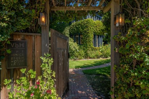 an entrance to a garden with a pergola at Venice Beach House in Los Angeles