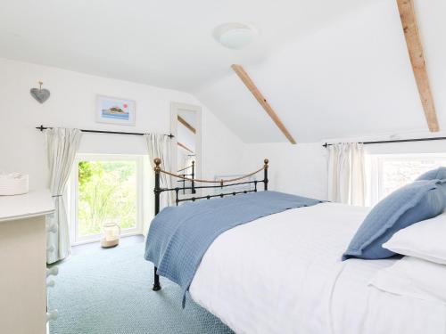 a white bedroom with a bed and a window at Waterside - Ukc4054 in Nancledra