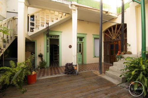 a house with a wooden deck and a door at Mini Loft 2 en El CIrculo in Guatemala