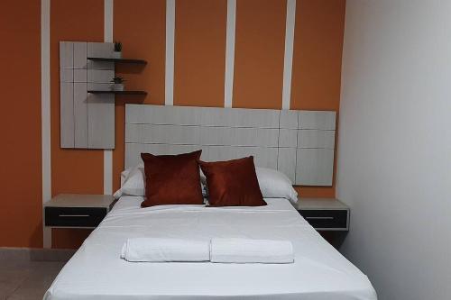 1 cama con 2 almohadas en una habitación en Aparta-Estudio, en Medellín
