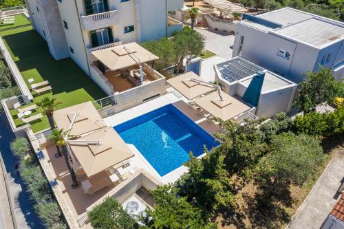 an aerial view of a house with a swimming pool at Apartments DYANA in Novalja