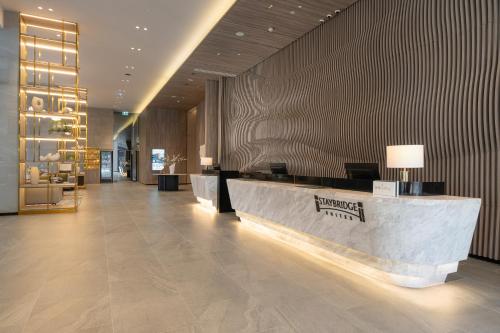 a lobby of a hotel with a reception desk at Staybridge Suites Bangkok Sukhumvit, an IHG Hotel in Bangkok