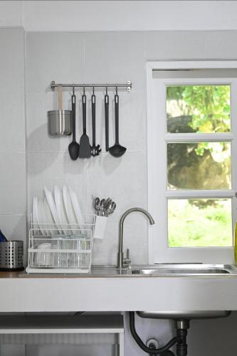 a kitchen counter with a sink and a window at Bao Village in Haad Yao