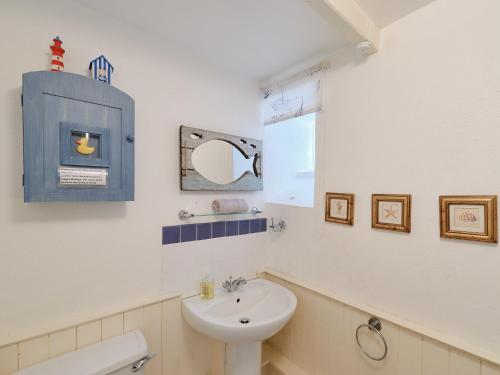 a bathroom with a sink and a toilet and a mirror at Farm Cottage - Ukc4056 in Nancledra