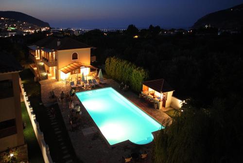 an overhead view of a swimming pool at night at Sun Accommodation in Skopelos Town