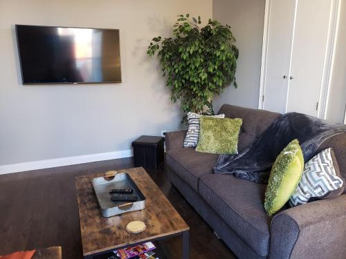 a living room with a couch and a table at Fresh Modern Industrial split level in Cincinnati