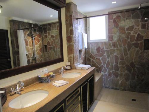 a bathroom with two sinks and a large mirror at Rabbit Resort Pattaya in Pattaya South
