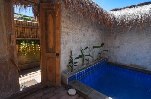a room with a swimming pool in a house at La Bella - Hotel Villa & Spa in Gili Trawangan