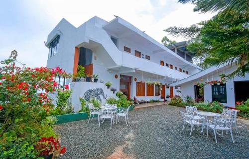 a view of the front of the house with tables and chairs at Leisure Mount Villa in Haputale