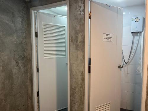 a bathroom with a shower and a white door at S30 in Bangkok