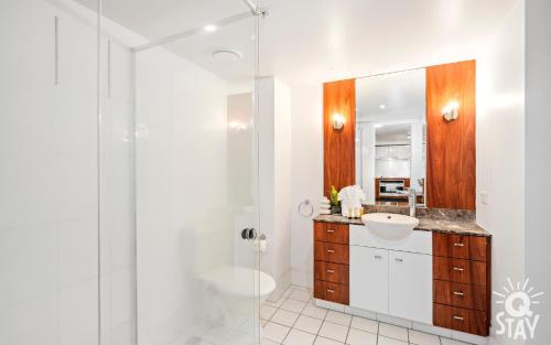 a white bathroom with a sink and a shower at 2 Bedroom 1 Bathroom Apartment - Centre of Surfers Paradise, Chevron Renaissance in Gold Coast