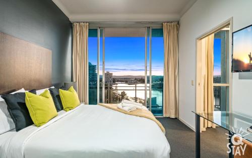 a bedroom with a large bed and a large window at 2 Bedroom 1 Bathroom Apartment - Centre of Surfers Paradise, Chevron Renaissance in Gold Coast