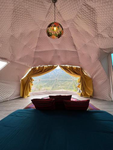 a room with a bed in a tent with a window at Mường Sang Retreat in Mộc Châu