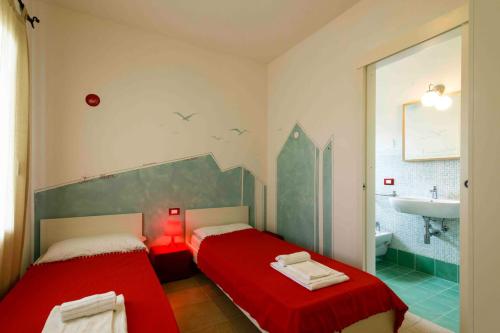 Giường trong phòng chung tại Residence Ea Bianca