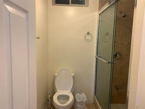 a bathroom with a toilet and a glass shower at Guest House Room No 01 in Mississauga
