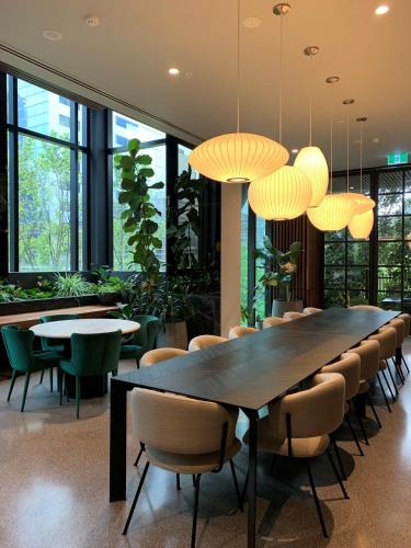 a dining room with a large table and chairs at Paragon Apartments by CLLIX in Melbourne