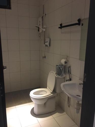 a bathroom with a toilet and a sink at Imperio Armanistay Alor Star in Alor Setar