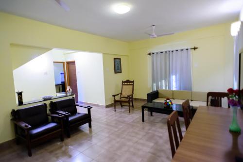 a living room with a couch and a table at Lifestyle villa in Candolim