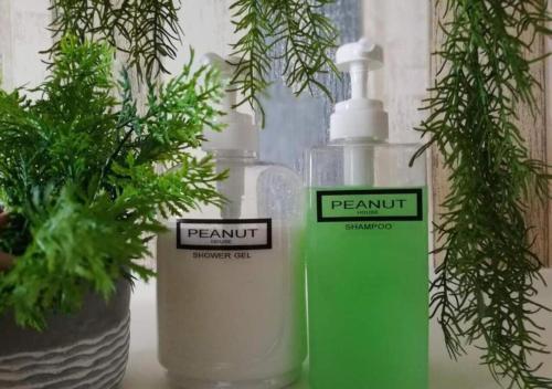 two bottles ofodorizers sitting next to plants on a table at Peanut Butter Homestay #Trefoil Setia City in Setia Alam