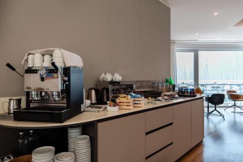 a kitchen with a coffee maker on a counter at Sestante Marina Motel in Capo dʼOrlando