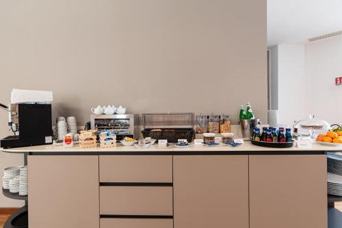 a kitchen counter with food and drinks on it at Sestante Marina Motel in Capo dʼOrlando