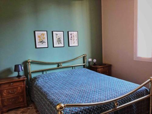 a bedroom with a bed and three pictures on the wall at Appartamento design dèco in Bologna