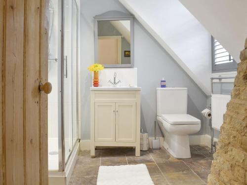 a bathroom with a white sink and a toilet at Stable Cottage in Margate