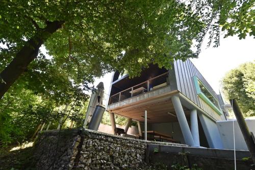 a house with a balcony on the side of it at Pensiunea Atra Doftana in Teşila