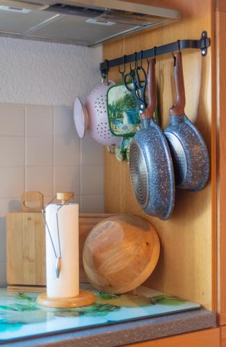 a kitchen with pots and pans hanging on a wall at Bahnhof Droyßig - Übernachten im Denkmal in Droyßig