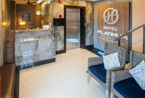 a lobby of a hotel with two chairs and a sign at RedDoorz Plus @ Hotel Platinum Occidental Mindoro in San Jose