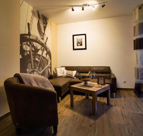 a living room with a couch and a table at Charming Apartments am See in Bad Saarow