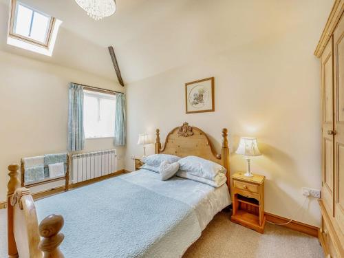 a bedroom with a large bed and a window at The Stables in Laneham