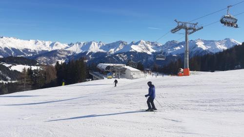 a person on skis in the snow on a ski lift at Lärchenhof Serfaus in Serfaus