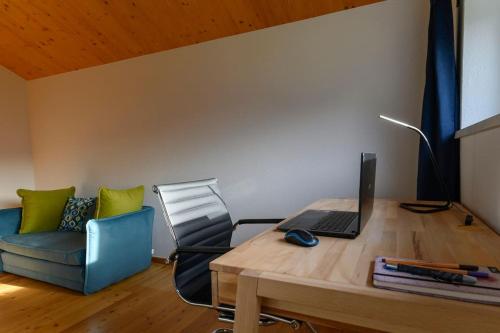 an office with a desk with a laptop and a chair at Ferienlodge MariAndl in Bad Goisern