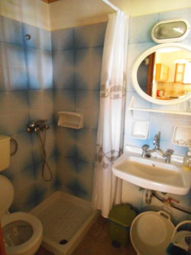 a small bathroom with a sink and a toilet at Villa Xenos in Kalamaki