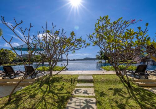 a view of a body of water with two chairs at Dayang Bay Resort Langkawi in Kuah