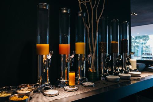 a table with some candles and some drinks on it at Villa Csonka by Privo in Târgu-Mureş