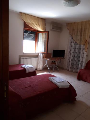 Postel nebo postele na pokoji v ubytování B&B Porta del Gargano